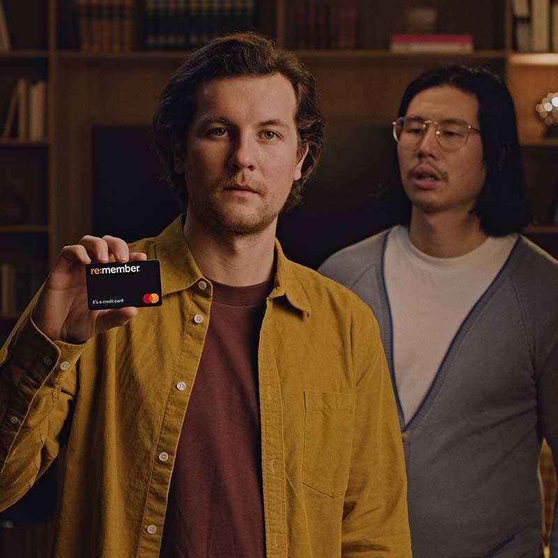 Två män varav en håller i ett re:member flex kreditkort